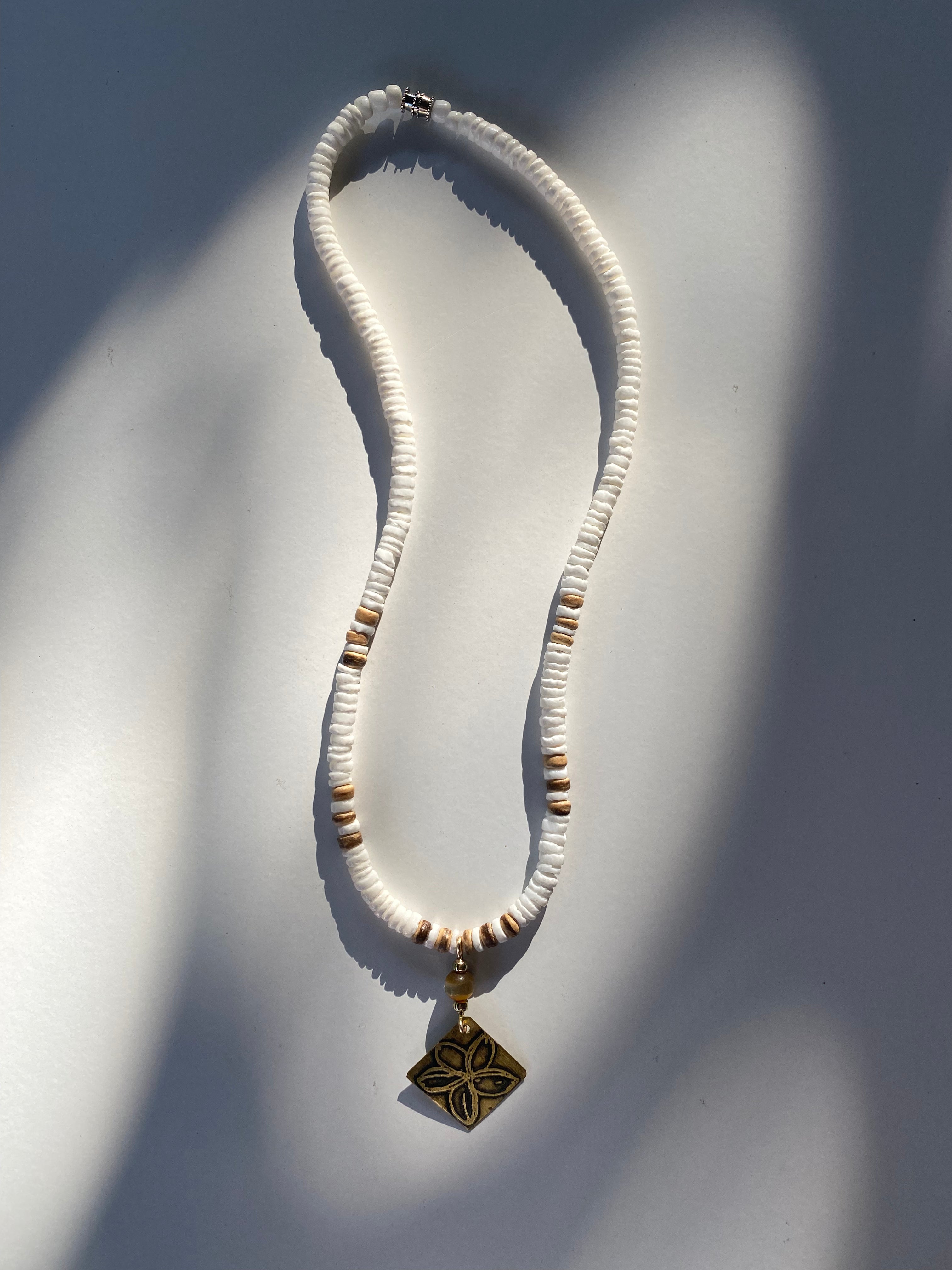 Puka shell necklace with best sale flower